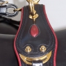 Monograms on a rosette, decorative leather pads, and gold-plated brass harness fittings